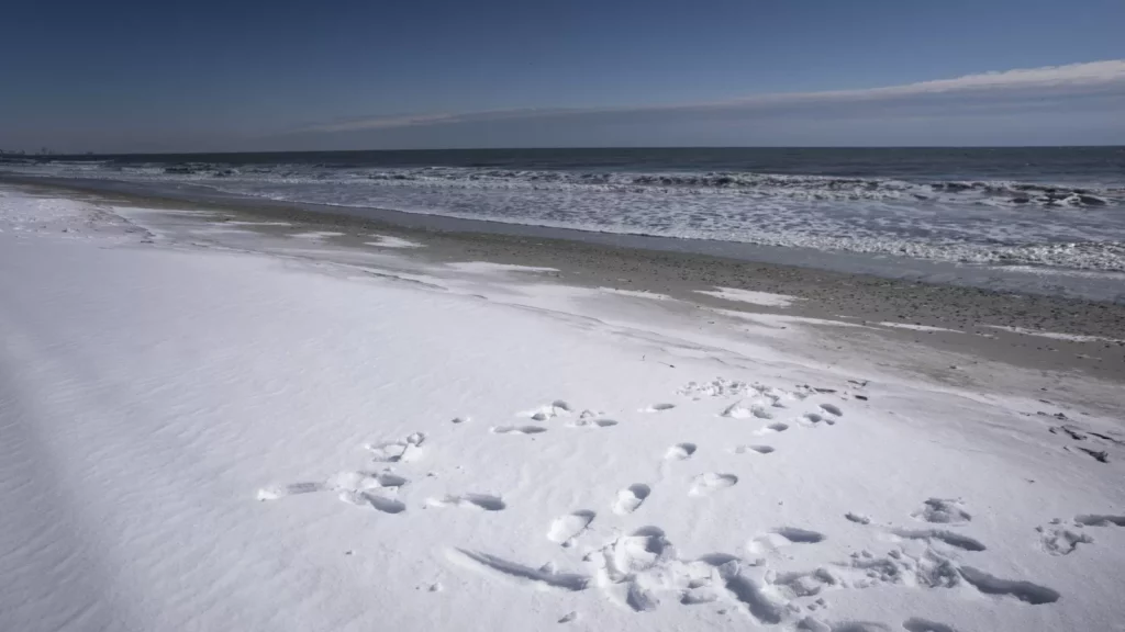 Watch: Snow Covers the Beach in Rare Event – It’s a Must-See!